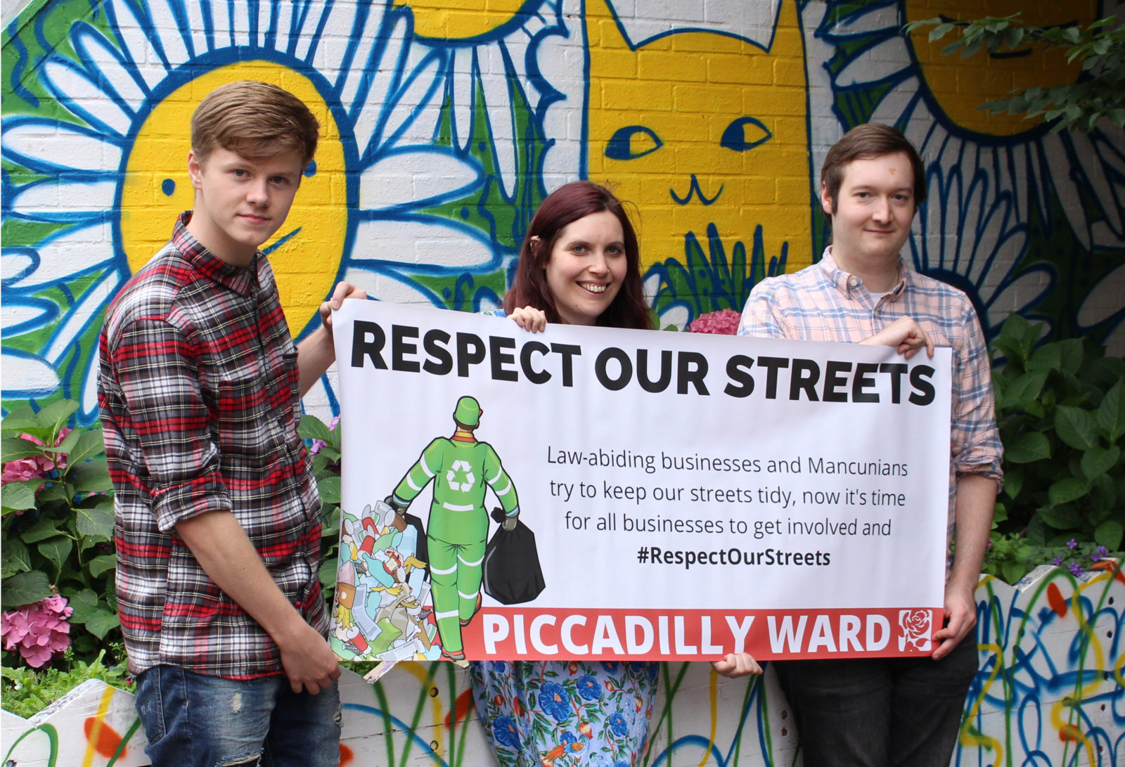Sam, Adele and Jon-Connor holding their campaign banner