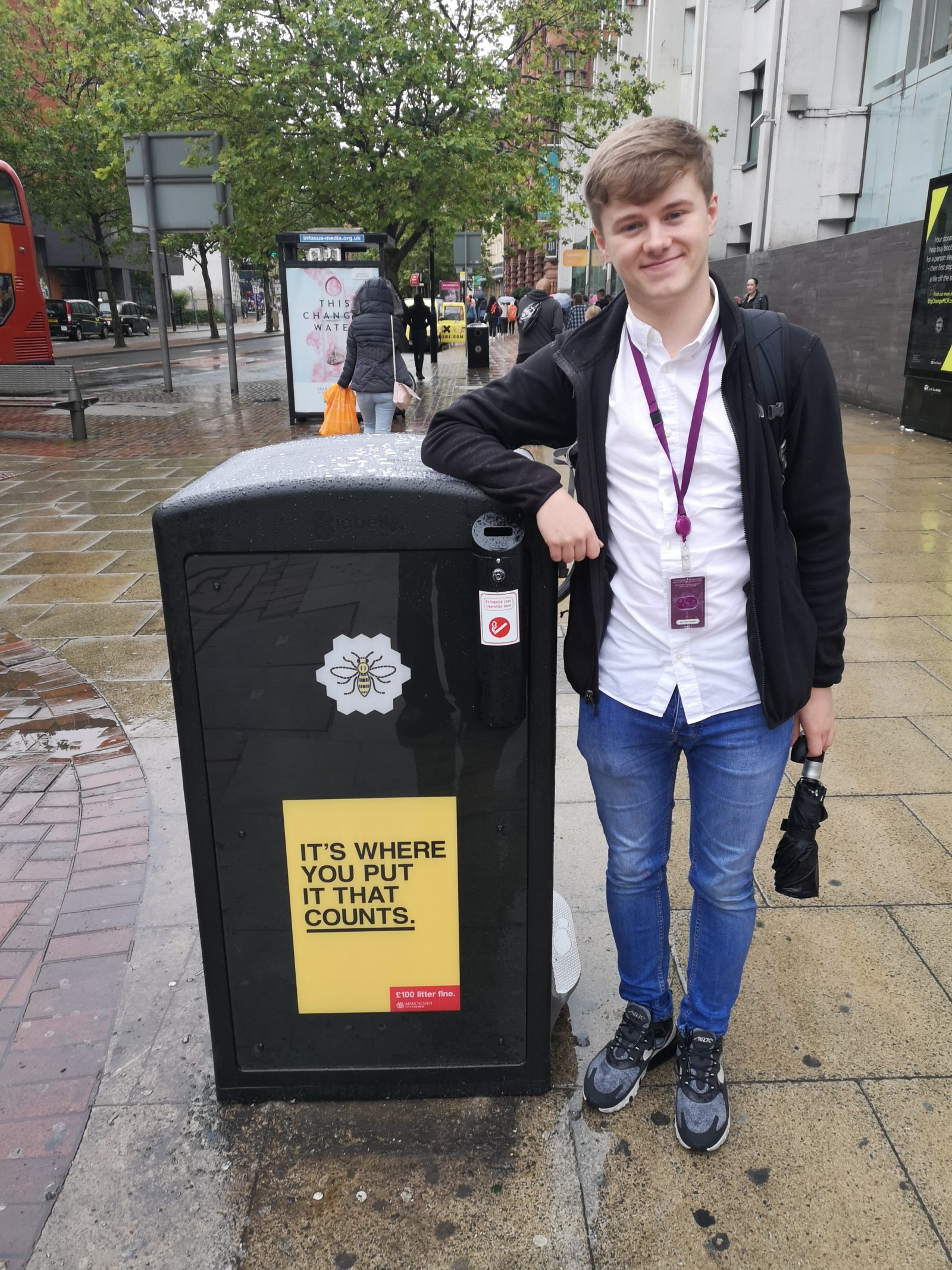 Cllr Jon-Connor Lyons standing next to the first Big Belly Bin to be installed in Manchester